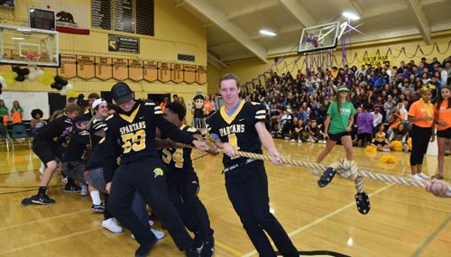 Students playing tug-of-war during a rally